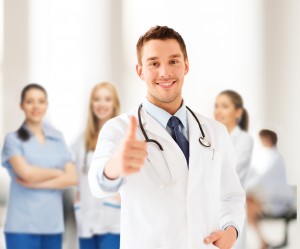 doctor with stethoscope showing thumbs up